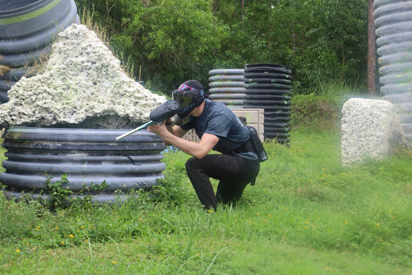 Player crouched behind a bunker, aiming down the field