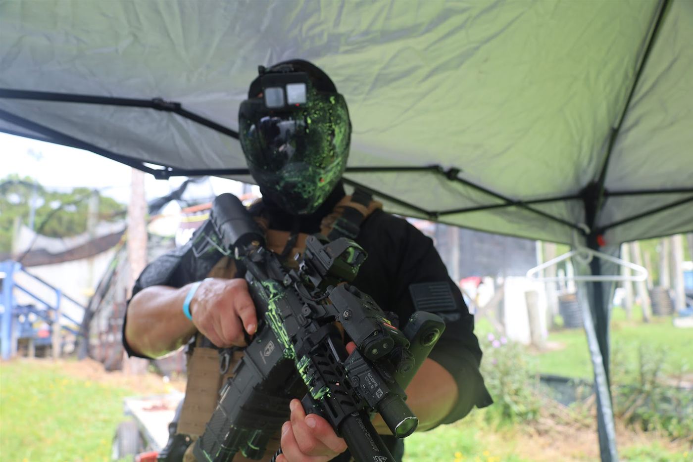 Player in a paint-splattered mask holding a rifle